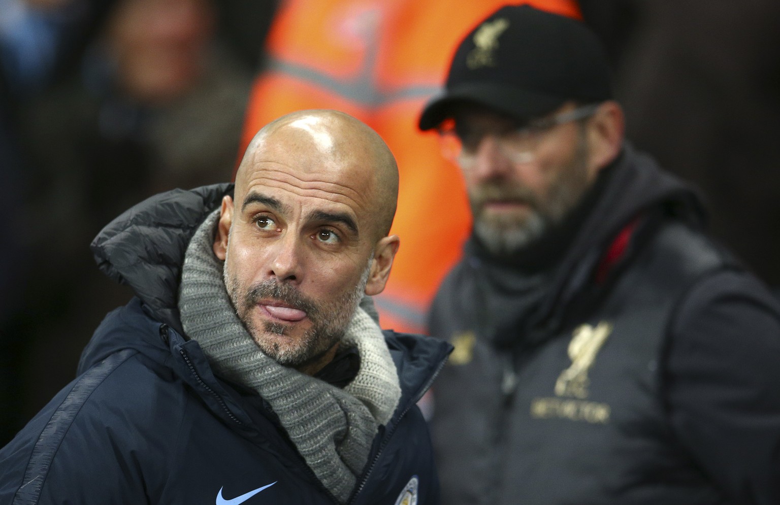 Manchester City&#039;s coach Pep Guardiola, left, passes Liverpool&#039;s coach Juergen Klopp before the English Premier League soccer match between Manchester City and Liverpool at the Etihad Stadium ...