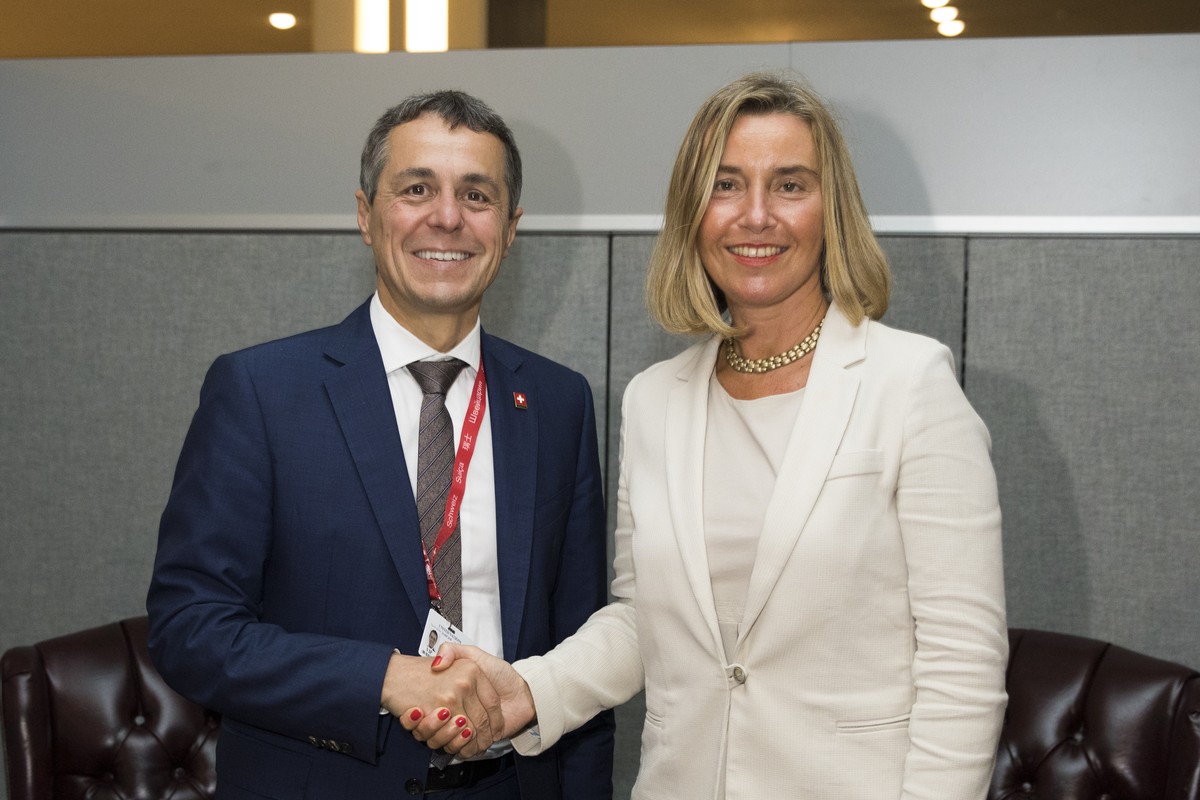 Swiss Foreign Minister Ignazio Cassis, left, and Federica Mogherini, European Union's High Representative for Foreign Affairs and Security Policy, right, shake hands during a bilateral meeting at ...