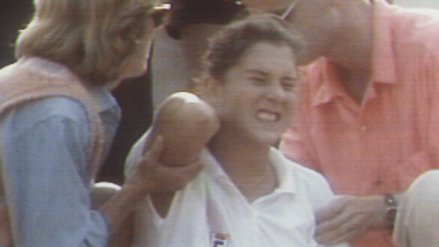 Die Tennisspielerin Monica Seles tastet mit schmerzverzerrtem Gesicht nach einer Wunde, die ihr kurz zuvor bei einem Messerstecher-Attentat zugefuegt wurde (Aufnahme vom 30. April 1993 in Hamburg). Da ...