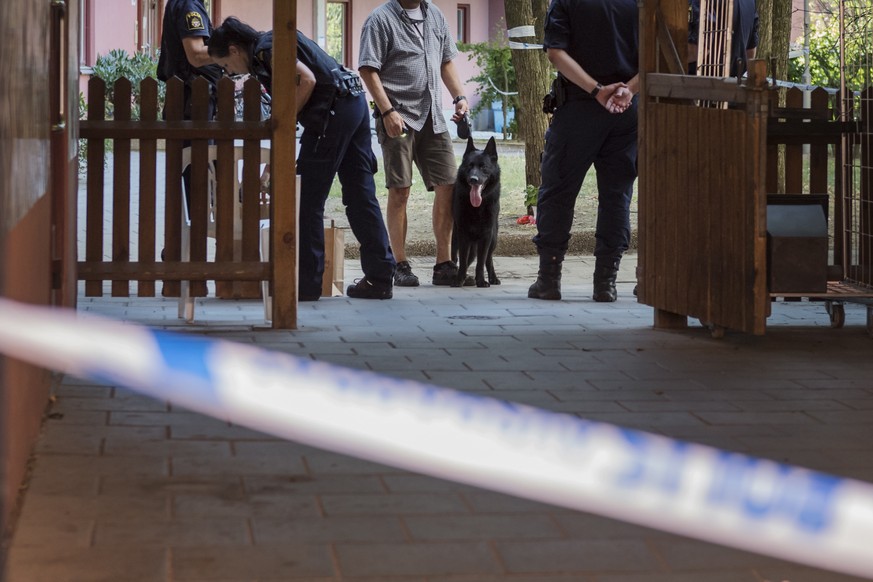 epa06925626 Police technicians search the site where a 20-year-old man was shot and killed by Swedish Police in Stockholm, Sweden, 03 August 2018. According to reports, a young man with a Down&#039;s  ...