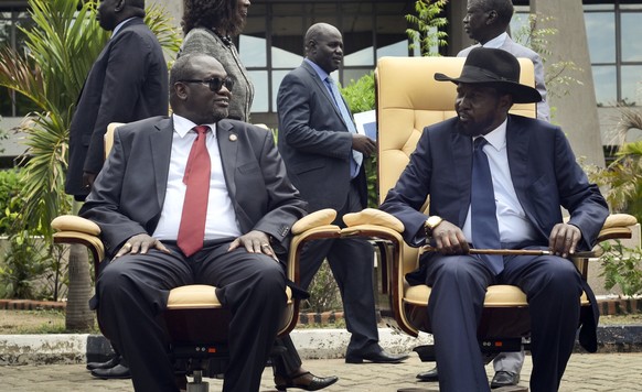 FILE - In this Friday, April 29, 2016 file photo, then South Sudan&#039;s First Vice President Riek Machar, left, looks across at President Salva Kiir, right, as they sit to be photographed following  ...