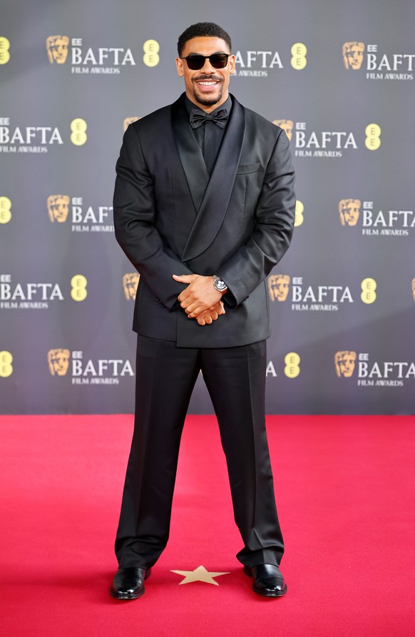 epa12768633 British actor Aaron Pierre poses on the red carpet at the EE BAFTA Film Awards 2026 at the Royal Festival Hall in London, Britain, 22 February 2026. The ceremony is hosted by the British A ...