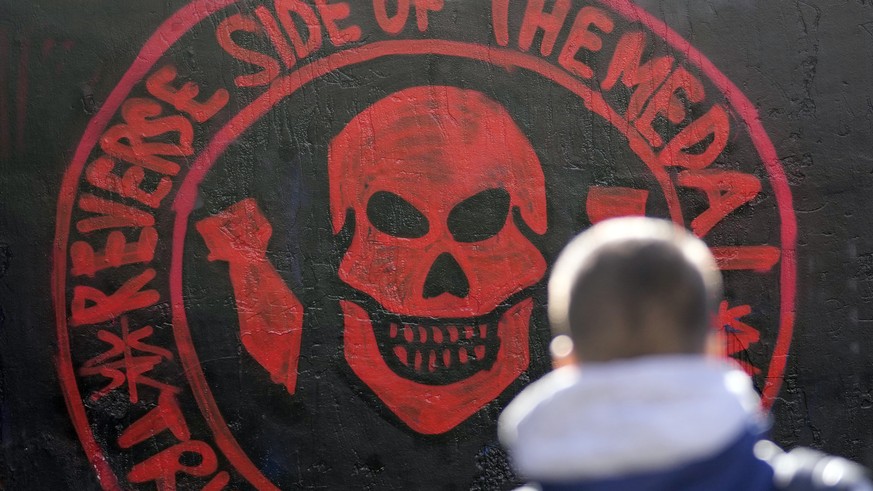 A boy walks by a repainted mural depicting the logo of Russia&#039;s Wagner Group on a wall in Belgrade, Serbia, Thursday, Jan. 19, 2023. (AP Photo/Darko Vojinovic)