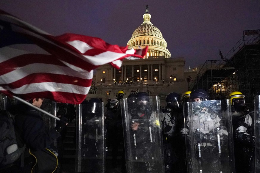 Police stand guard after a day of riots at the U.S. Capitol in Washington on Wednesday, Jan. 6, 2021. (AP Photo/Julio Cortez)