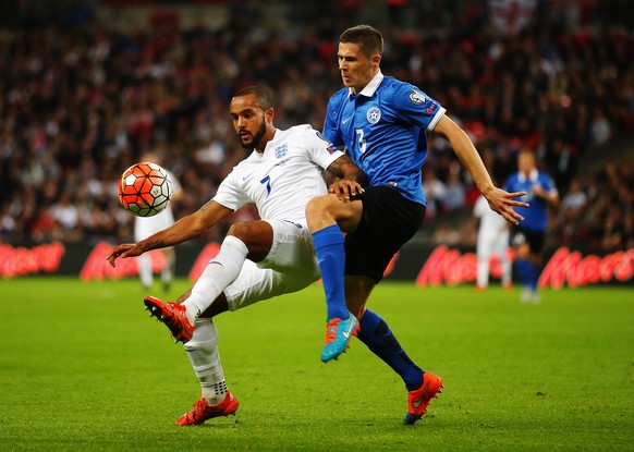LONDON, ENGLAND - OCTOBER 09: (L-R) Theo Walcott of England holds off the challenge of Artur Pikk of Estonia during the UEFA EURO 2016 Group E qualifying match between England and Estonia at Wembley o ...