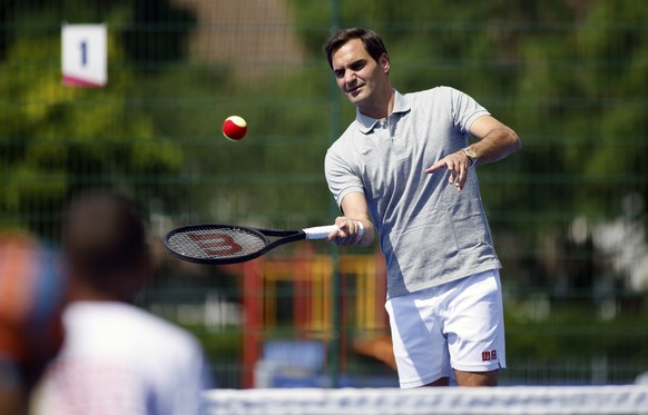 Roger Federer during a coaching session with local school children at the opening of newly refurbished park tennis courts at Bostall Gardens in Greenwich, London, Thursday June 15, 2023. (Steven Pasto ...