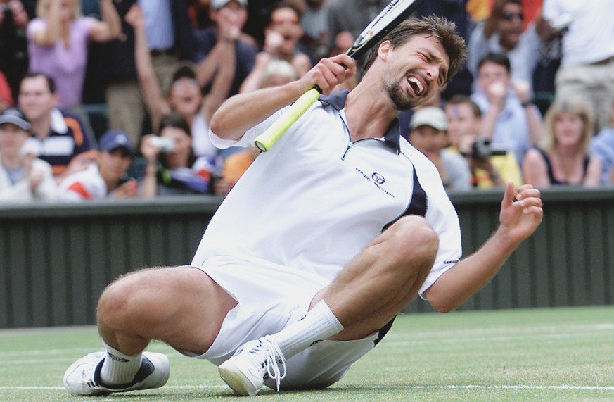 Goran Ivanisevic falls to the ground after defeating Patrick Rafter to win the men&#039;s singles final on the Centre Court at Wimbledon Monday July 9, 2001.(AP Photo/str) **UNITED KINGDOM OUT**