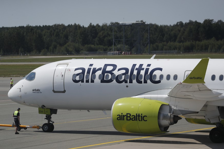 epa10084483 An aircraft Airbus A220-300 of Latvian airlines airBaltic prepares to take off at the Riga International Airport (RIX), in Riga, Latvia, 21 July 2022. Riga Airport is an emerging air traff ...