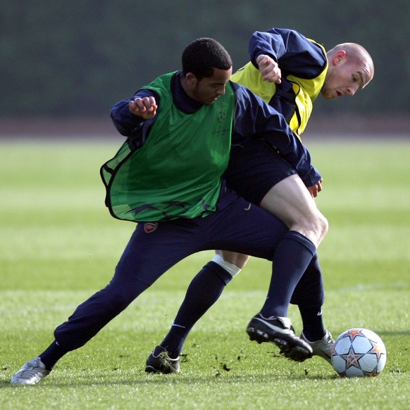 Arsenal's Theo Walcott, right, grapples with Philippe Senderos during their training session, London Colney Tuesday Feb. 19, 2008. Arsenal will face AC Milan in a Champions League round of 16 soc ...