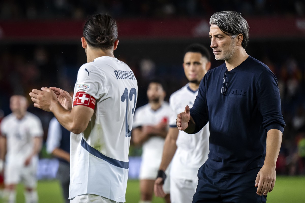 epa11728232 Switzerland head coach Murat Yakin (R) and player Ricardo Rodriguez shake hands after losing the UEFA Nations League soccer match between Spain and Switzerland in Santa Cruz de Tenerife, S ...