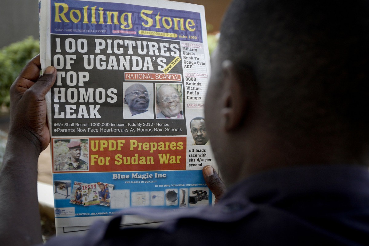 A Ugandan man reads the headline of the Ugandan newspaper "Rolling Stone" in Kampala, Uganda. Tuesday, Oct. 19, 2010, in which the papers reveals the identity of allegedly gay members of Uga ...