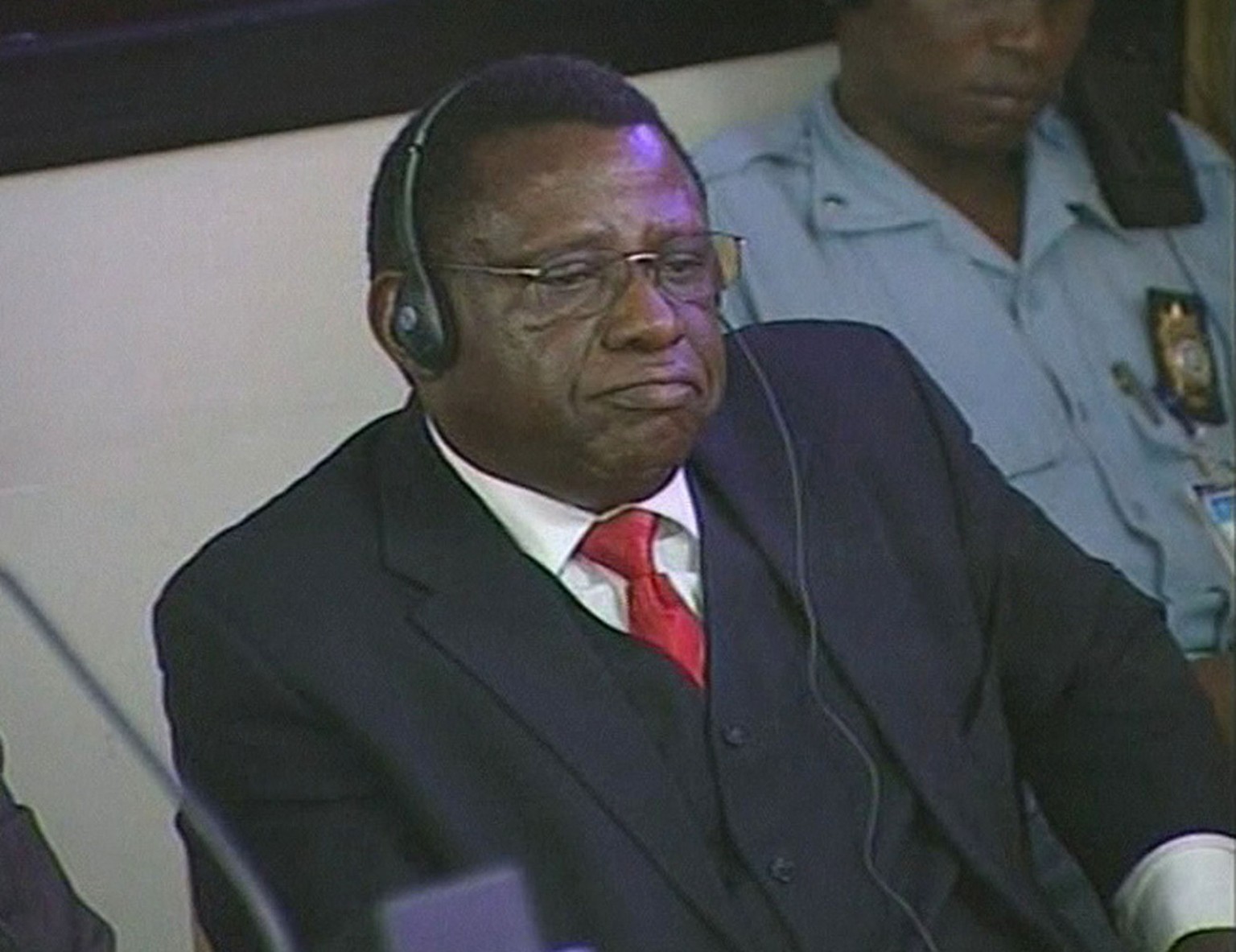 Theoneste Bagosora reacts as he sits in the court at the International Criminal Tribunal for Rwanda, in Arusha, Tanzania, Thursday, Dec. 18, 2008, where he was found guilty of genocide and crimes agai ...