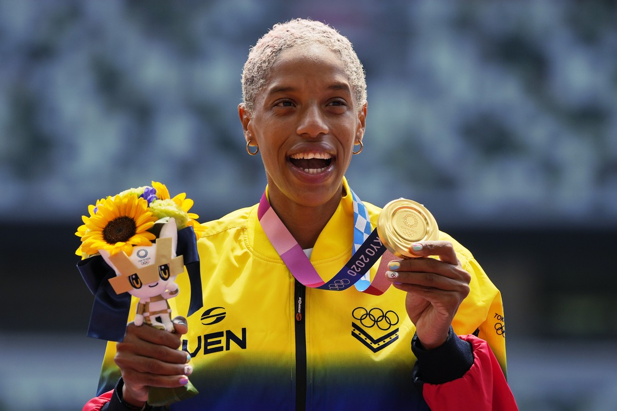 Yulimar Rojas, of Venezuela, poses with her gold medal for the women's triple jump at the 2020 Summer Olympics, Monday, Aug. 2, 2021, in Tokyo. (AP Photo/Francisco Seco)