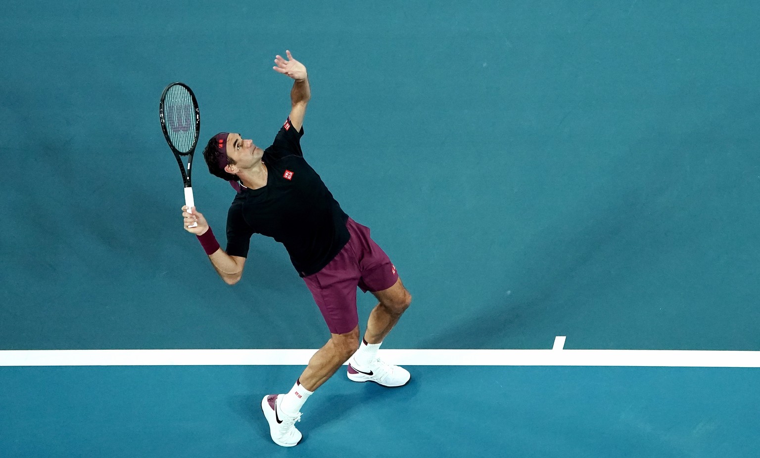 epa08143593 Roger Federer of Switzerland in action against Steve Johnson of the USA during a first round match on day one of the Australian Open tennis tournament at Melbourne Park in Melbourne, Austr ...