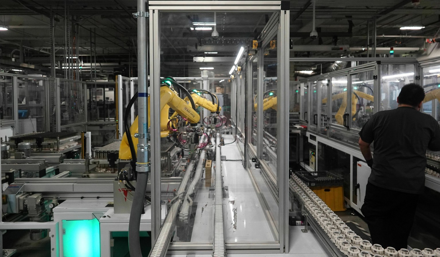 FILE - In this Dec. 3, 2018 photo, robots at the Tesla Gigafactory help assemble battery cells from Panasonic into battery packs for Tesla&#039;s Model 3 sedan and other products in Reno, Nev. Tesla s ...
