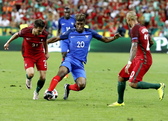 epa05419429 Kingsley Coman of France (C) and Cedric of Portugal in action during the UEFA EURO 2016 Final match between Portugal and France at Stade de France in Saint-Denis, France, 10 July 2016.

 ...