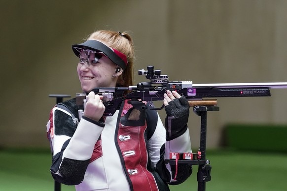 Nina Christen, of Switzerland, reacts after the last shot in the women&#039;s 50-meter 3 positions rifle at the Asaka Shooting Range in the 2020 Summer Olympics, Saturday, July 31, 2021, in Tokyo, Jap ...