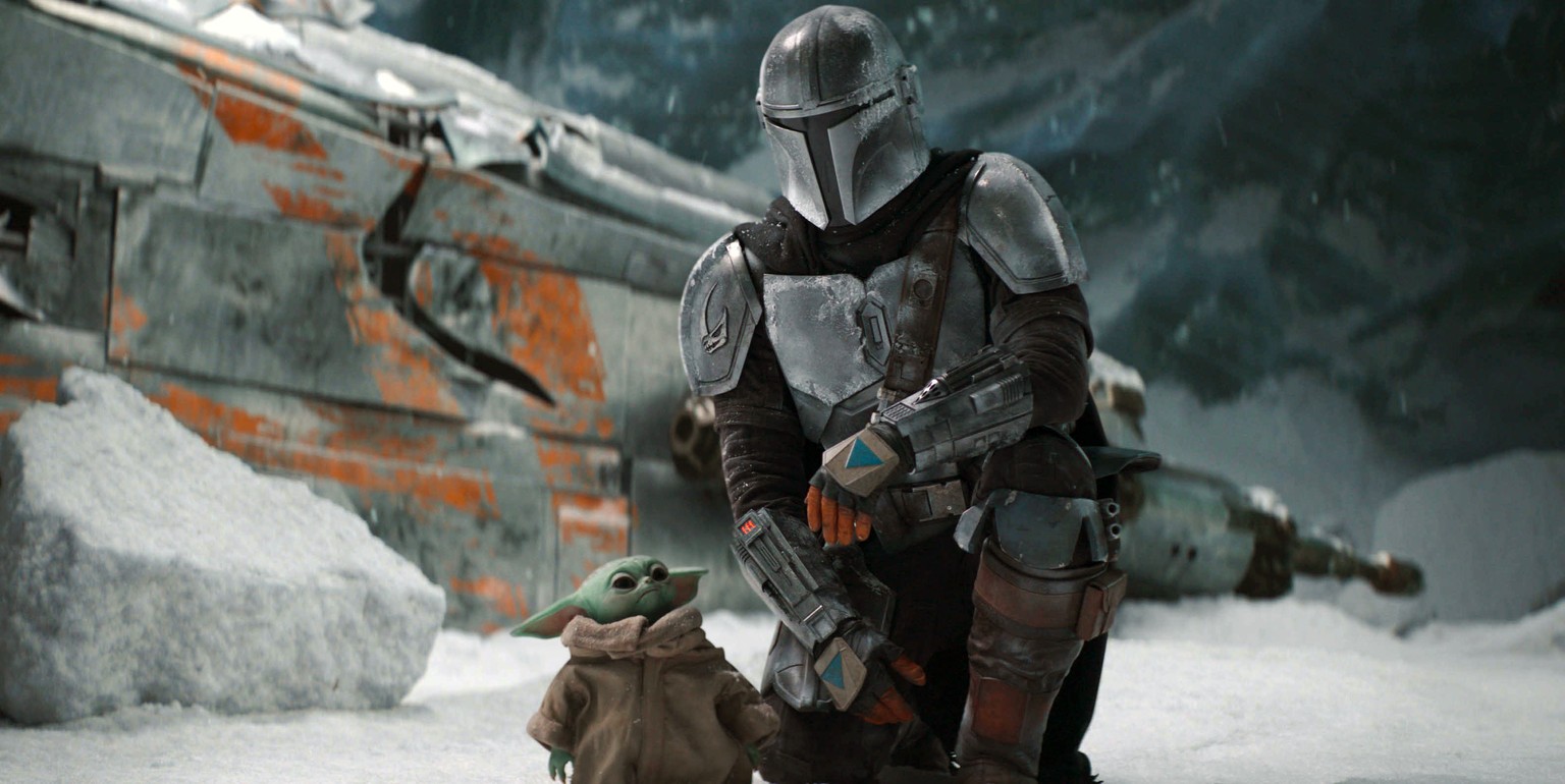 This image released by Disney Plus shows Pedro Pascal, as Din Djarin, right, with The Child, in a scene from &quot;The Mandalorian,&quot; premiering its second season on Friday. (Disney Plus via AP)