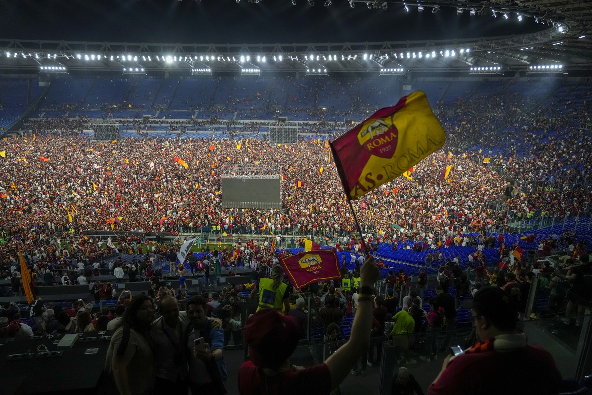 Supporters of AS Roma celebrate inside the Olympic Stadium in Rome their team's victory of the Europa Conference League final soccer match between Roma and Feyenoord being played in Tirana, Wedne ...