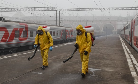 epa09559142 Russian Emergency Situations Ministry workers wearing protective suits disinfect the Kazansky Railway Station amid the ongoing coronavirus COVID-19 pandemic in Moscow, Russia, Russia, 02 N ...