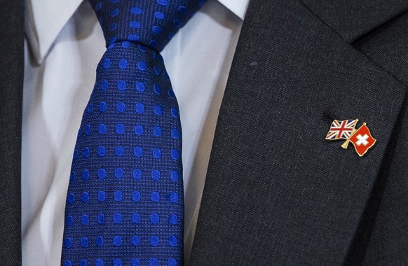 epa07361792 The flags of Switzerland and Great Britain on the jacket of British Secretary of State for International Trade Liam Fox, after signing a trade agreement with Swiss Federal Councillor Guy P ...