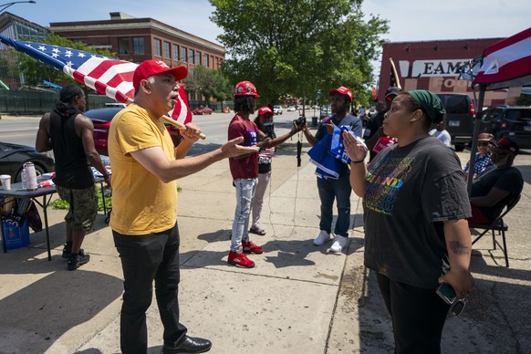 epa11478051 Supporters of former US president Donald J. Trump argue with supporters of US President Joe Biden during a small Trump Unity Rally in Chicago Illinois, USA, 14 July 2024. Trump was injured ...