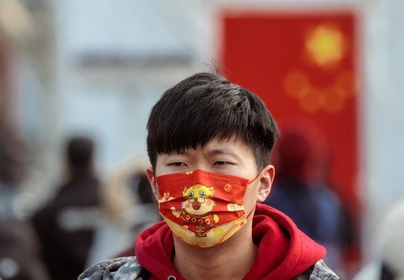 epa10417725 A person walks at the Shanghai Railway Station in Shanghai, China, 20 January 2023. Millions of people travel back to their hometowns to celebrate the lunar New Year and spend time with th ...