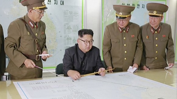 FILE - In this file image made from video of an Aug. 14, 2017, broadcast in a news bulletin by North Korea's KRT, North Korean leader Kim Jong Un receives a military briefing in Pyongyang. Conven ...