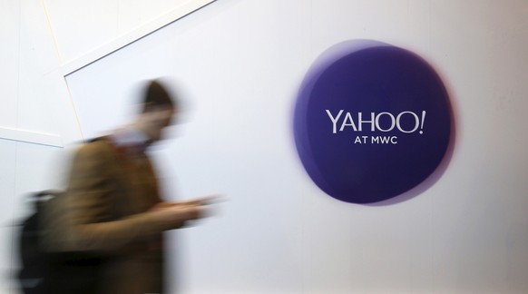 A man walks past a Yahoo logo during the Mobile World Congress in Barcelona, Spain in this February 24, 2016 file photo. REUTERS/Albert Gea/File Photo