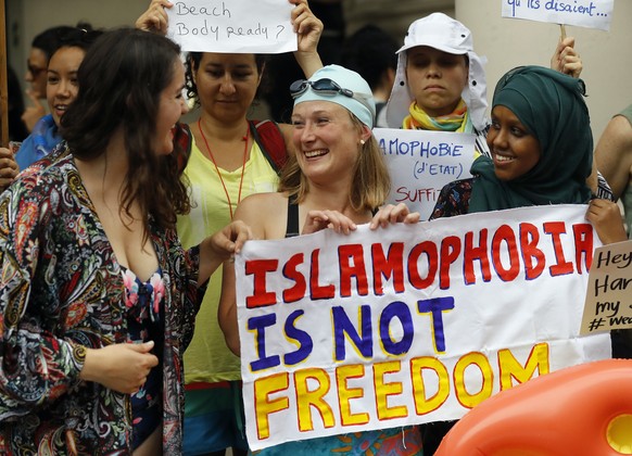 Activists protest outside the French embassy during, the &quot;wear what you want beach party&quot; in London, Thursday, Aug. 25, 2016. The protest is against the French authorities clampdown on Musli ...