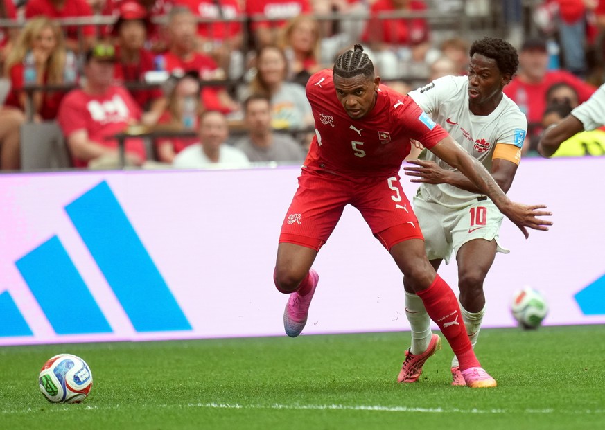 epa13061745 Manuel Akanji of Switzerland (L) and Jonathan David of Canada in action during the FIFA World Cup 2026 group stage match Switzerland against Canada, in Vancouver, Canada, 24 June 2026. EPA ...
