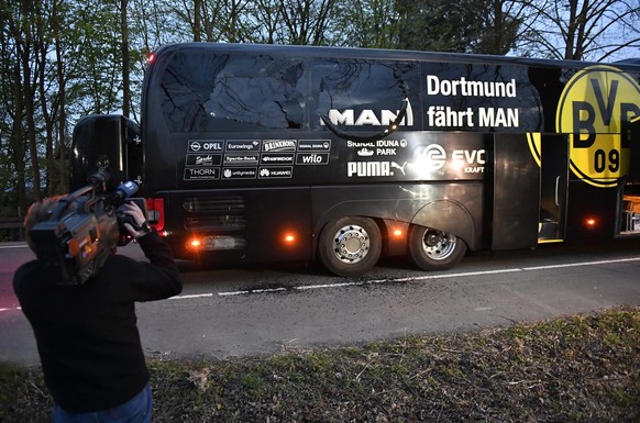 A camera man films Dortmund&#039;s team bus after it was damaged in an explosion before the Champions League quarterfinal soccer match between Borussia Dortmund and AS Monaco in Dortmund, western Germ ...