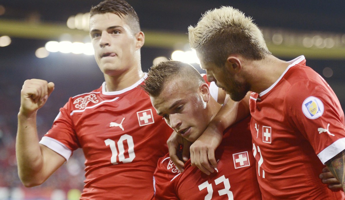 Switzerland's Xherdan Shaqiri, center, celebrates with Valon Behrami, right, and Granit Xhaka, left, after the first goal for Switzerland during a Worldcup qualification soccer match between Swit ...