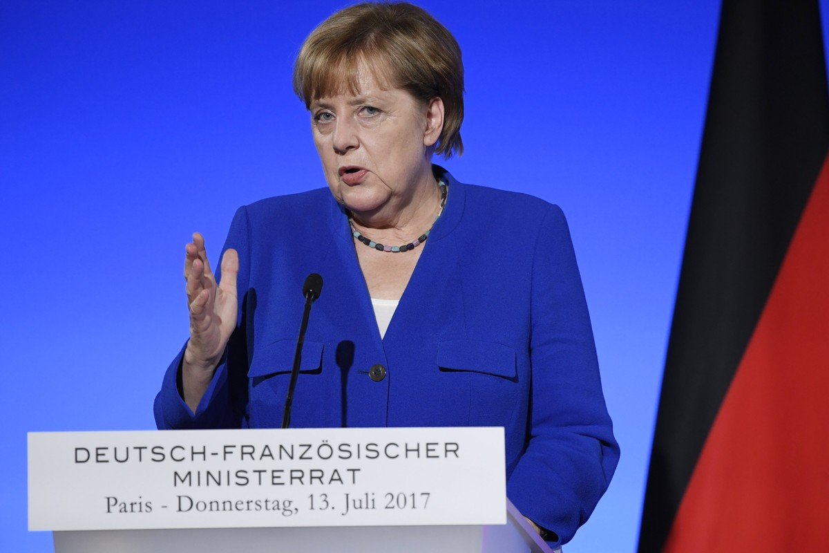 epa06084975 German Chancellor Angela Merkel speaks at a joint news conference with French President Emmanuel Macron (unseen) at the Elysee Palace in Paris, 13 July 2017. The French-German Ministerial  ...