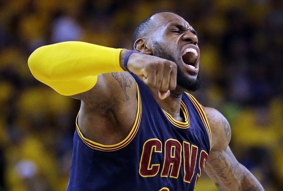 Cleveland Cavaliers forward LeBron James (23) celebrates after end of the overtime period of Game 2 of basketball's NBA Finals against the Golden State Warriors in Oakland, Calif., Sunday, June 7, 2015. The Cavaliers won 95-93 in overtime. (AP Photo/Ben Margot)