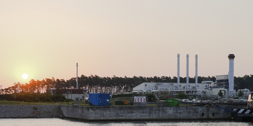 The sun rises behind the landfall facility of the Nord Stream 1 Baltic Sea pipeline and the transfer station of the OPAL gas pipeline, the Baltic Sea Pipeline Link, in Lubmin, Germany, Thursday, July  ...