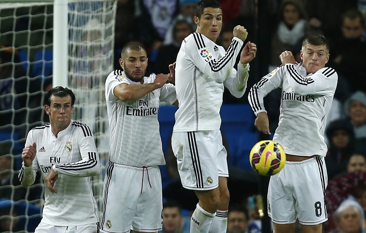 Real Madrid's Gareth Bale, left, Cristiano Ronaldo, second right, Toni Kroos, right, and Karim Benzema, second left, protect themselves from the ball during a Spanish La Liga soccer match against ...