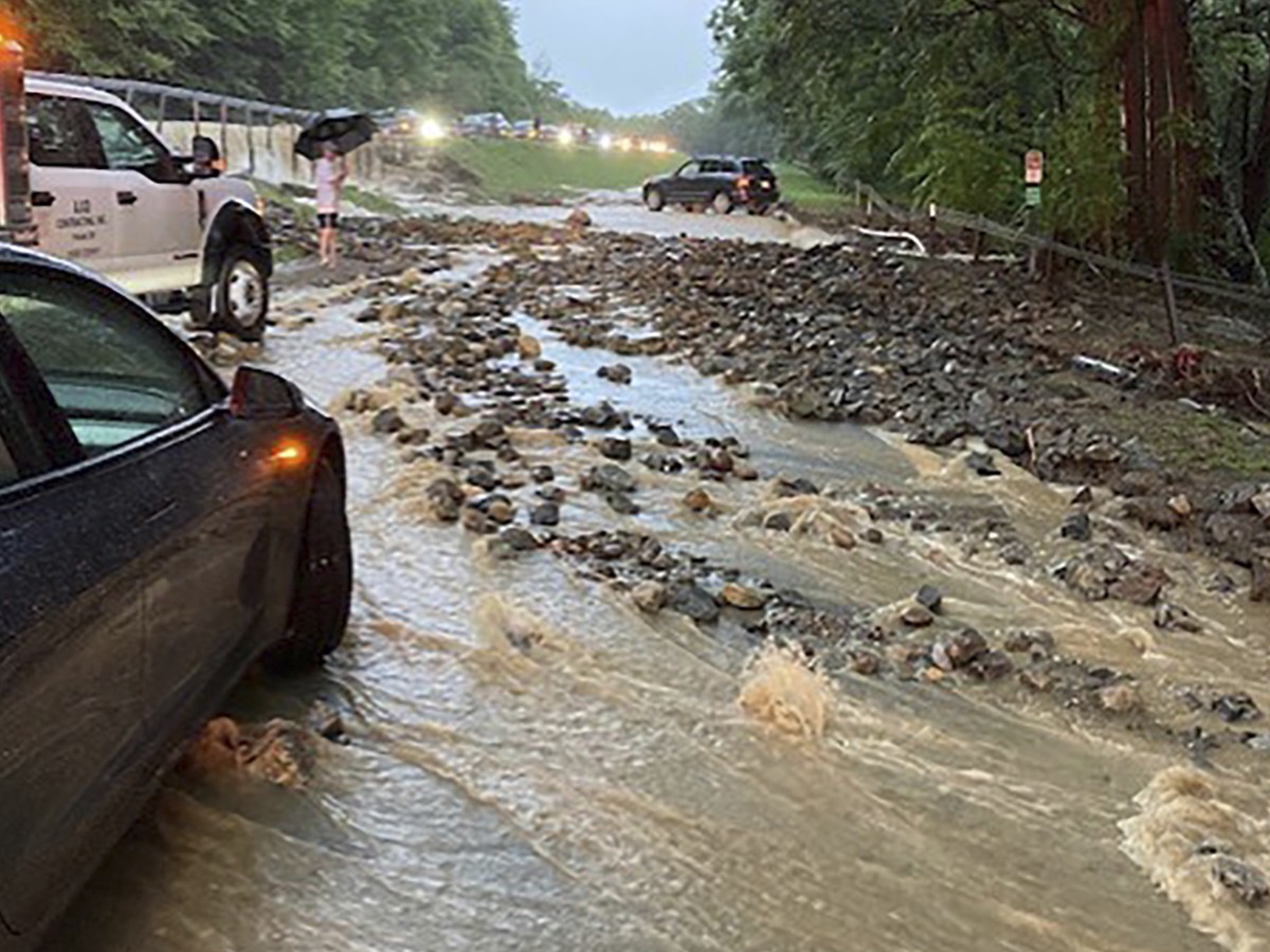 Vehicles come to a standstill near a washed-out and flooded portion of the Palisades Parkway just beyond the traffic circle off the Bear Mountain Bridge, Sunday, July 9, 2023, in Orange County, N.Y. H ...