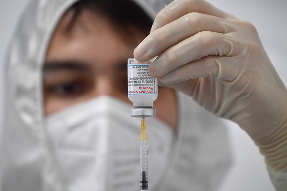 epa09131049 A medical staff handles the Moderna vaccine against COVID-19 at the vaccination hub Casa della Salute, in the MSC tower at S.Benigno in Genoa, Italy, 12 April 2021. The hub for the adminis ...