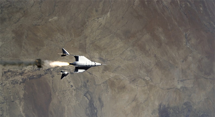 This Saturday, May 22, 2021 image provided by Virgin Galactic shows the release of VSS Unity from VMS Eve and ignition of rocket motor over Spaceport America, N.M. Virgin Galactic completed its third  ...