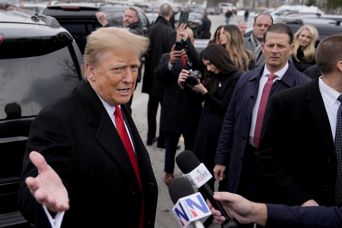Republican presidential candidate former President Donald Trump, left, addresses members of the press during a campaign stop in Londonderry, N.H., Tuesday, Jan. 23, 2024. (AP Photo/Matt Rourke)