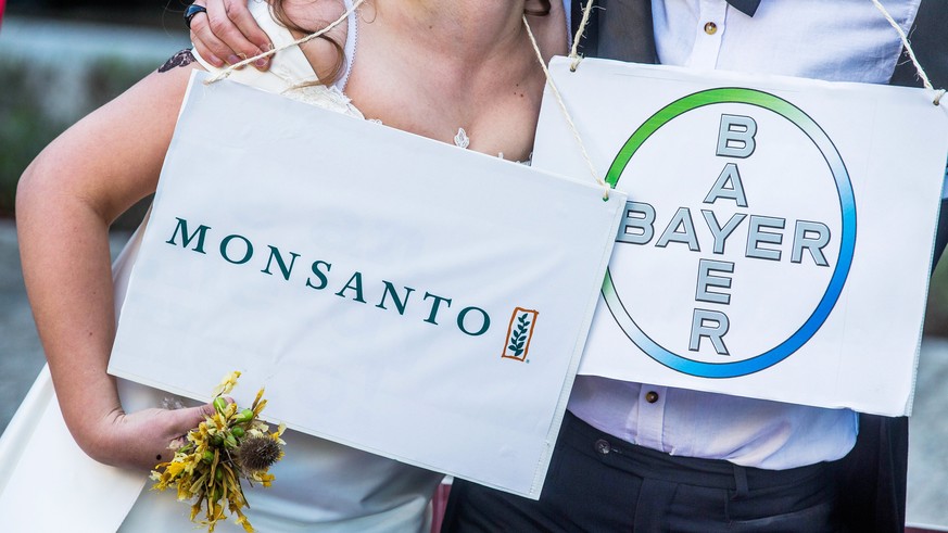epa06618054 (FILE) - A woman and a man dressed as bride and groom pose during an action &#039;marriage made in hell&#039; to denounce the threat posed by the planned merger of Bayer and Monsanto in fr ...