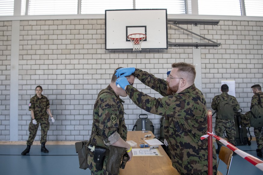 Die Koerpertemperatur wird bei den Soldaten gemessen, anlaesslich des Zusammenzugs der Soldaten des Spitalbataillon 5 die aus verschiedenen Teilen der Schweiz einrücken, am Montag, 16. Maerz 2020 in d ...