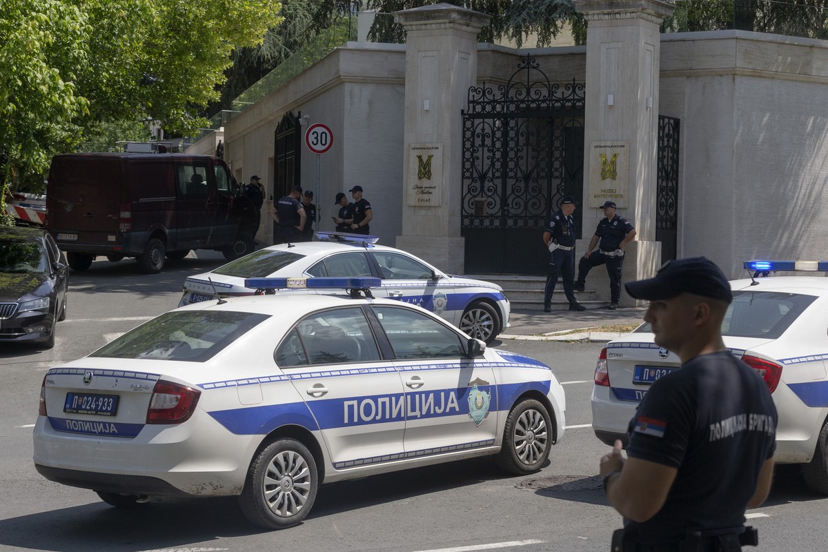 Police officers block off traffic at an intersection close to the Israeli embassy in Belgrade, Serbia, Saturday, June 29, 2024. An attacker with a crossbow wounded a Serbian police officer guarding th ...
