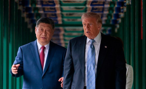 U.S. President Donald Trump, right, participates in a friendship walk through Zhongnanhai Garden with Chinese President Xi Jinping in Beijing, Friday, May 15, 2026. (Evan Vucci/Pool Photo via AP)
Chin ...