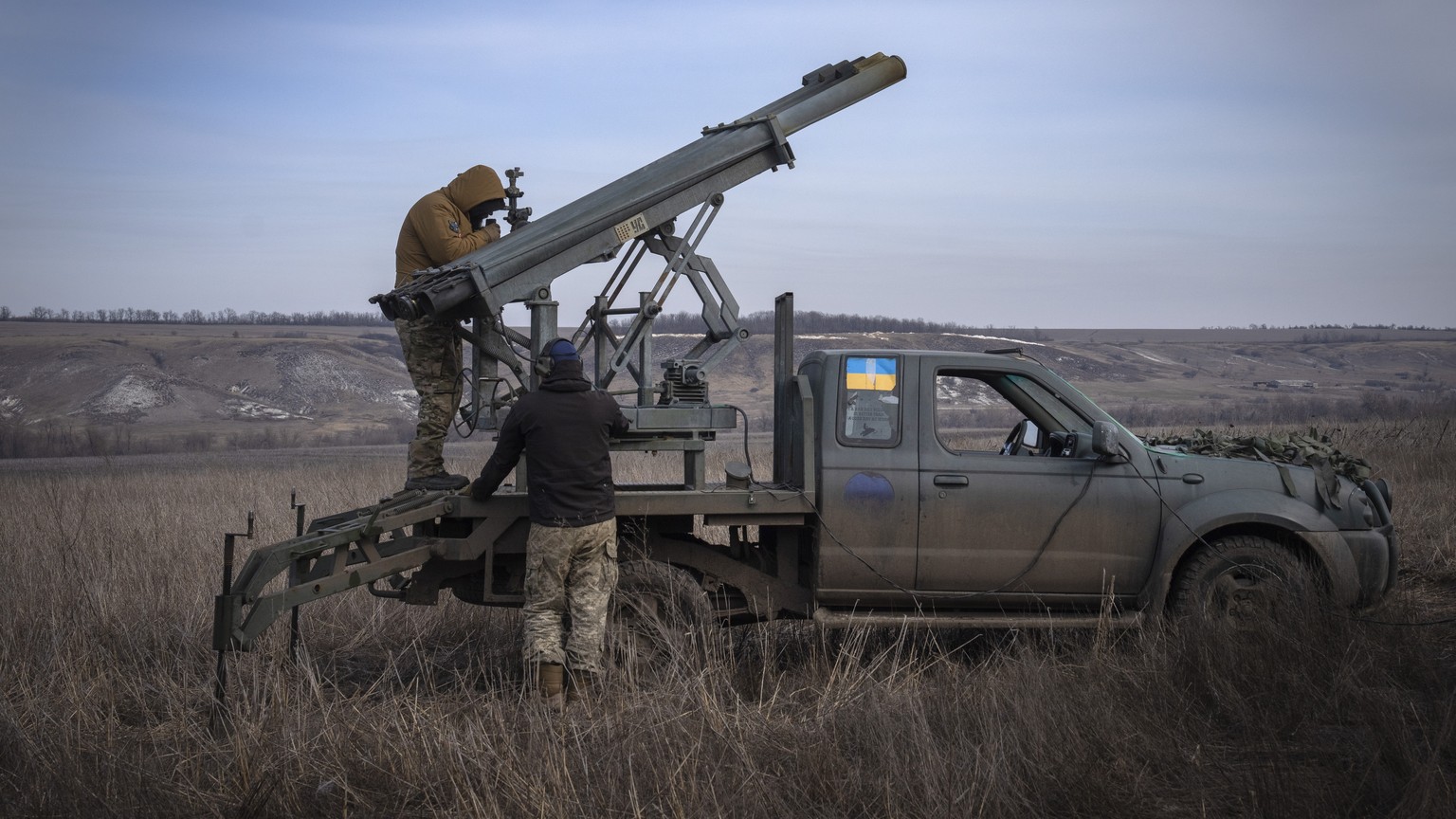 FILE - Ukrainian soldiers from The 56th Separate Motorized Infantry Mariupol Brigade prepare to fire a multiple launch rocket system based on a pickup truck towards Russian positions at the front line ...