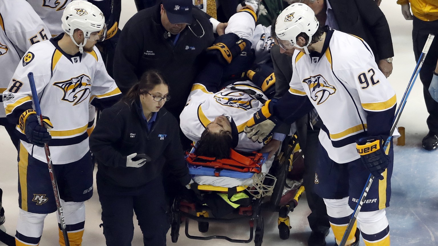 Nashville Predators&#039; Ryan Johansen (92) and Viktor Arvidsson, left, of Sweden, offer encouragement to teammate Kevin Fiala, of Switzerland, as Fiala is taken off on a stretcher after being injure ...