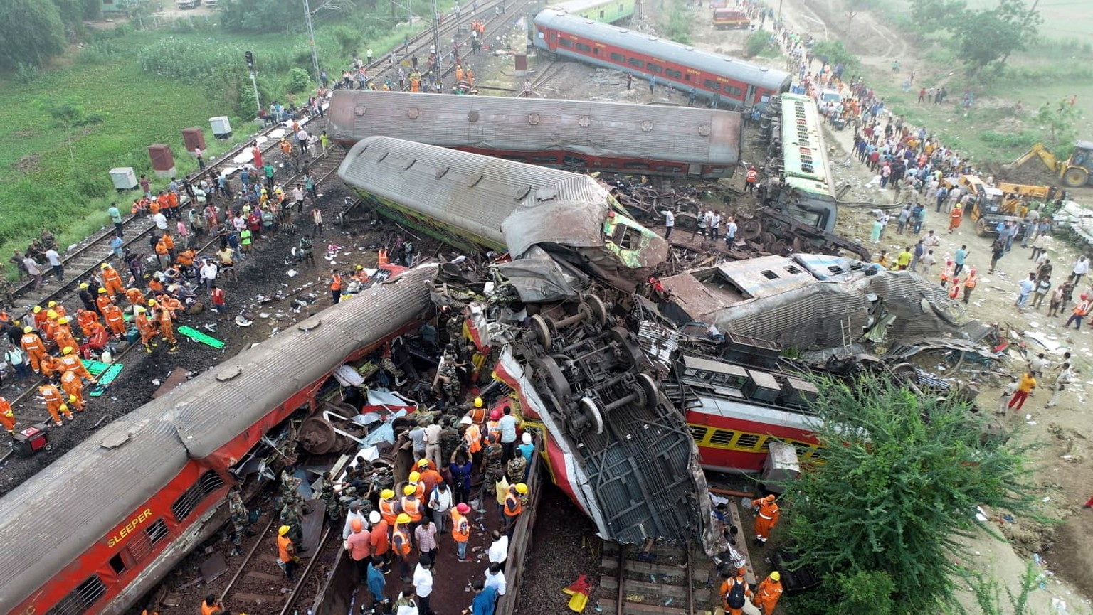 epa10669895 A handout photo provided by India's National Disaster Response Force (NDRF) and taken by drone shows the location of a train accident in Odisha Balasore, India, June 03, 2023. Ov...