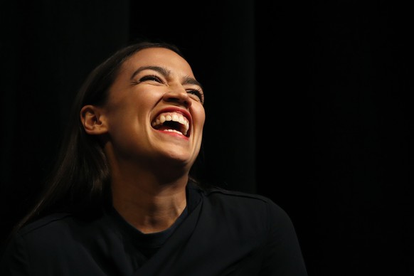 New York congressional candidate Alexandria Ocasio-Cortez laughs while listening to a speaker at a fundraiser Thursday, Aug. 2, 2018, in Los Angeles. The 28-year-old startled the party when she defeat ...