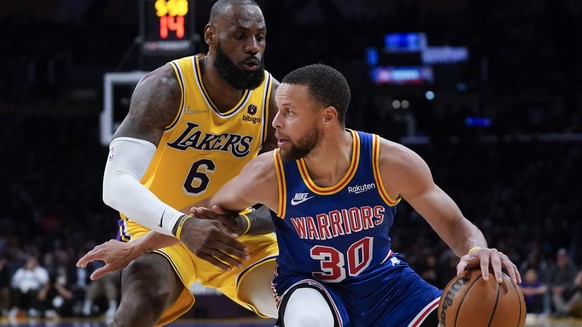 Los Angeles Lakers forward LeBron James (6) defends against Golden State Warriors guard Stephen Curry (30) during the second half of an NBA basketball game in Los Angeles, Saturday, March 5, 2022. (AP ...